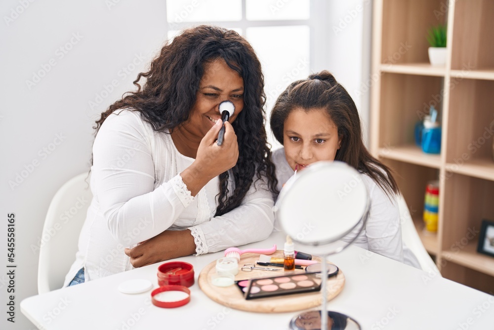 Mother and daughter smiling confident applying make up at home Mother and daughter smiling confident applying make up at home