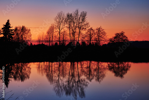 Fototapeta Naklejka Na Ścianę i Meble -  Colourful tree reflections after sunset.  Serpentine Fen, Surrey, BC