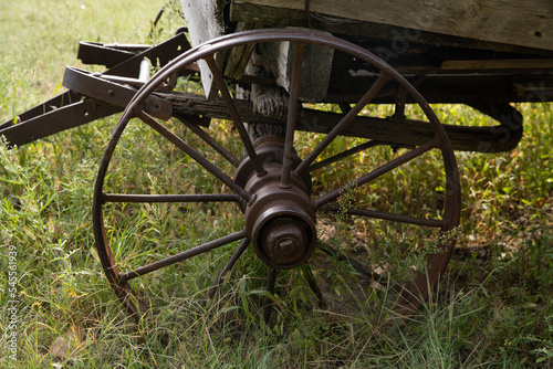 Old wagon wheel in a field 