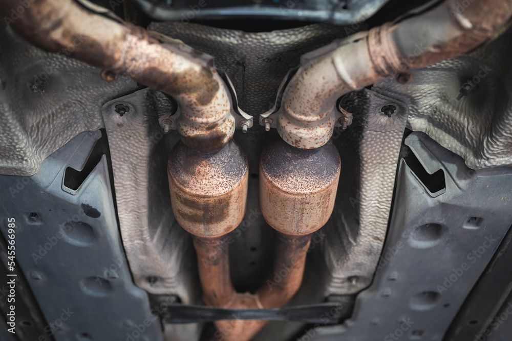 Close-up of catalytic converter in car exhaust system. Close-up of catalytic converter in car exhaust system.