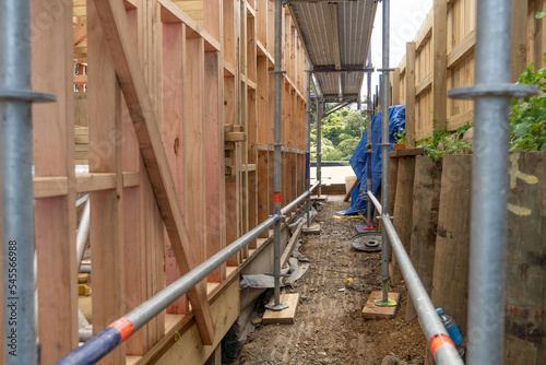 Metal scaffolding and wood building construction, building site photo