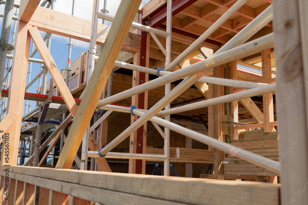 Metal scaffolding and wood building construction, building site Metal scaffolding and wood building construction, building site