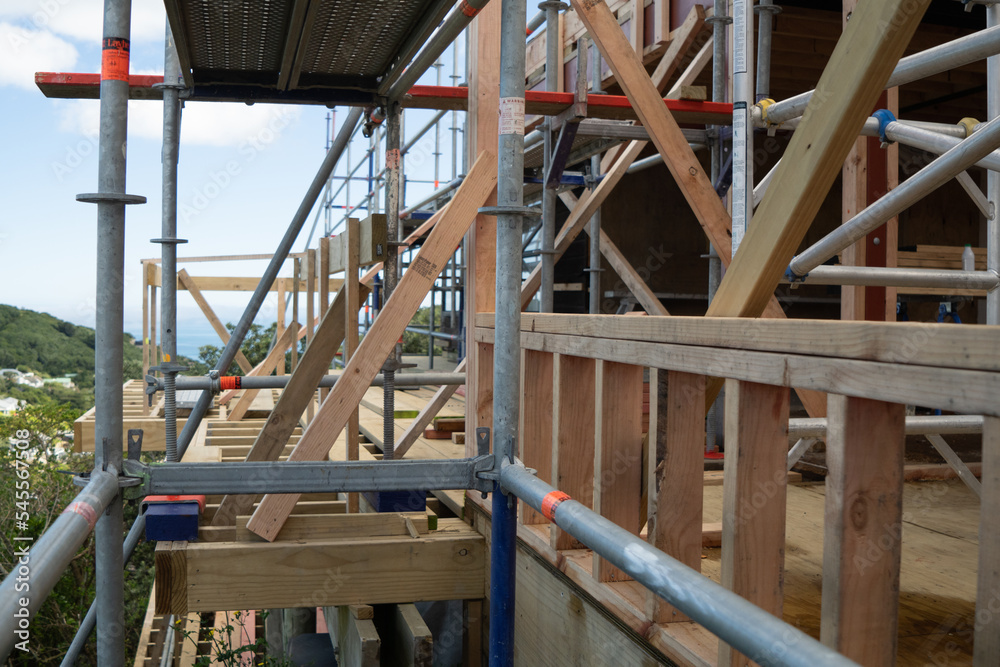 Metal scaffolding and wood building construction, building site Metal scaffolding and wood building construction, building site