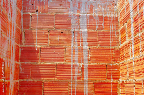 Brick wall under construction of brazilian house, brick under construction in brazil. blocks or bricks (masonry) of red clay on a wall, in the work of Brazilians. photo