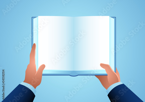 Mans hand holding an opened book