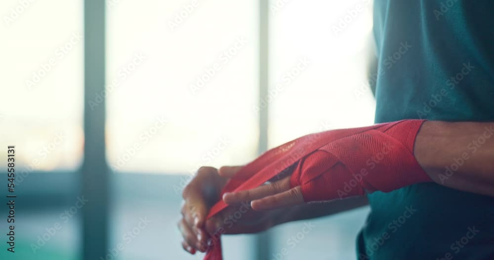 Hands, fighter and bandage wrapping fist for boxing sports, training or exercise in preparation for match. Hand of boxer tying gloves getting ready for fighting competition, practice or gym workout