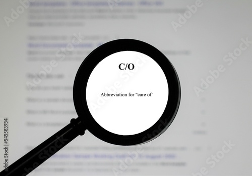Selective focus on the abbreviation C-O, word in a dictionary. Close up of an English dictionary page with abbreviation C-O meaning care of.