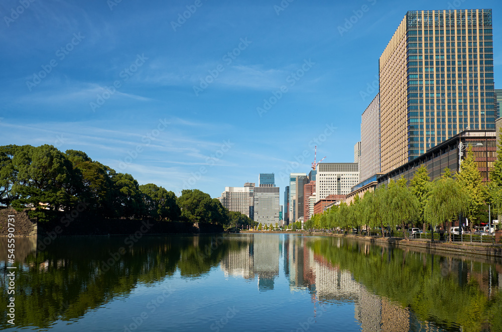 Skyscrapers of Marunouchi district reflecting in the water of Edo castle outer moat. Tokyo. Japan Skyscrapers of Marunouchi district reflecting in the water of Edo castle outer moat. Tokyo. Japan