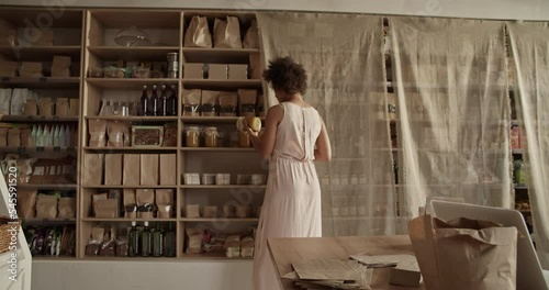 Female worker of eco shop packing order