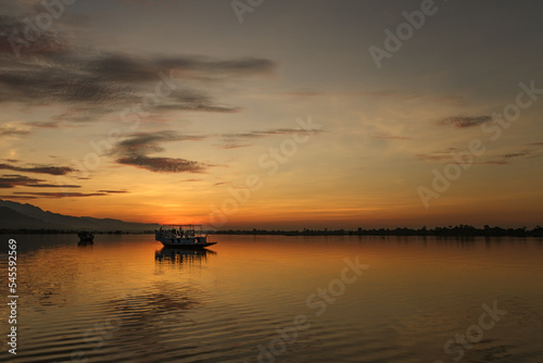 Sun rising at lake