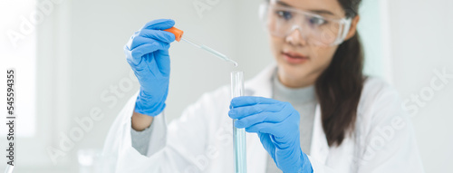 Fototapeta Naklejka Na Ścianę i Meble -  Medical development research laboratory, chemist or science woman scientist student in glass, glove looking pipette for test analysis liquid samples in clinic lab. Microbiology, analysing for medicine