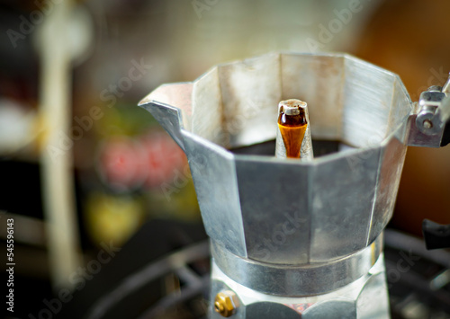 An image close-up selected focus of hot coffee in the moka pot is a pot coffee boiled in a holiday is beverage with caffeine on the stove background.