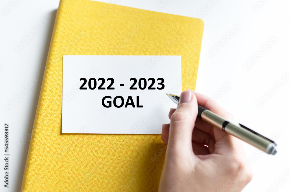 Businessman writes text on the card 2022-2023 goals Businessman writes text on the card 2022-2023 goals