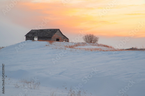Old shack on snowy field