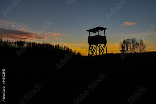 Hunting tower silhouette on sunset in blue and orange photo