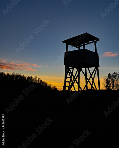 Hunting tower silhouette on sunset in blue and orange