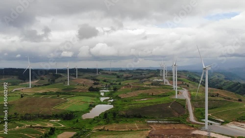 Wind mill farm on green mountain view. Clean energy from nature wind alternatie power concept.