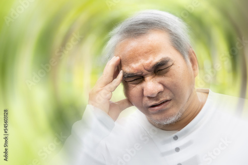 Old asian senior man suffering from headache, health and sickness concept for vertigo symptoms, dizziness, stress, stroke, depression, burnout, Alzheimer, brain cancer, Meniere disease, memory loss photo
