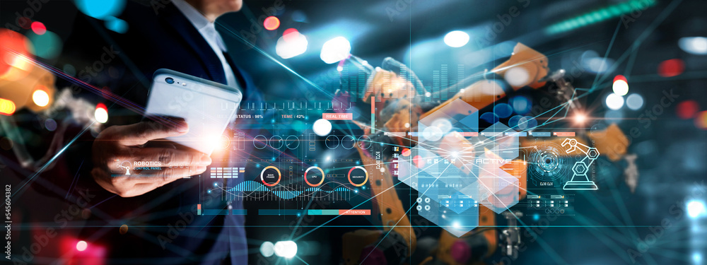 Obraz premium Technician manager, Industrial engineer control robotics on monitoring system software and icon industry network connection on smartphone. AI. Automation robot arm in smart factory. Industry 4.0