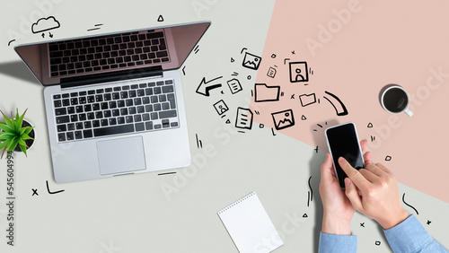 A person sends various files from a smartphone to a laptop using wireless technology.
