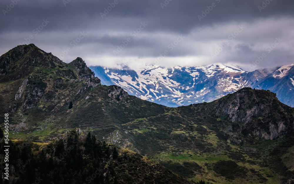 View on the snow mountains of the French Pyrenees near Ayes lake on a cloudy and moody day
