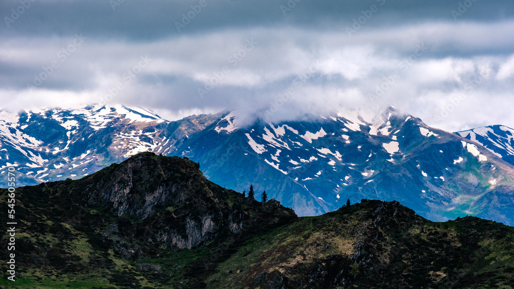 View on the snow mountains of the French Pyrenees near Ayes lake on a cloudy and moody day