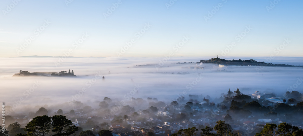 Auckland city and One Tree Hill in a sea of fog, view from Mt Eden summit.