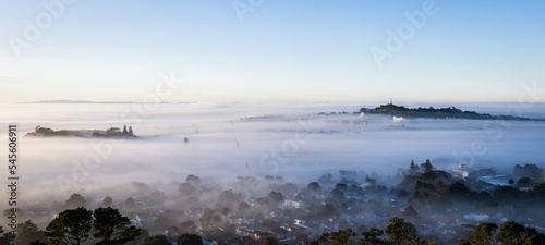 Auckland city and One Tree Hill in a sea of fog, view from Mt Eden summit.