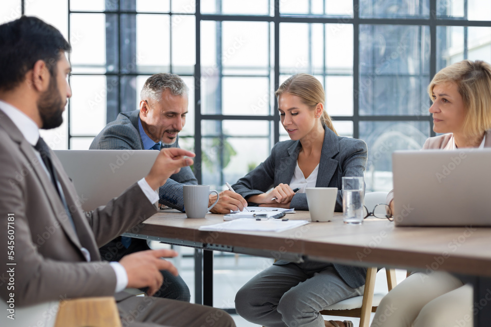 Business meeting - manager discussing work with his colleagues. Business meeting - manager discussing work with his colleagues.