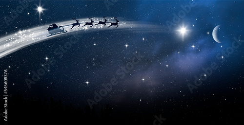 Santa Claus im Schlitten über einer Schneelandschaft bei Nacht