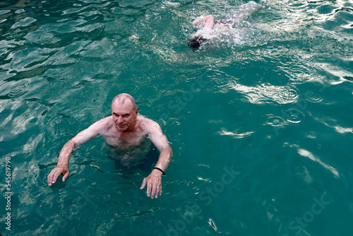 Senior man swimming in thermal pool