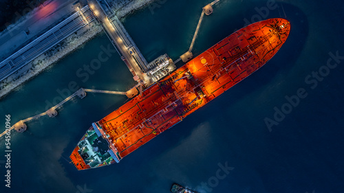 Aerial top view industrial crude oil fuel tanker ship at terminal industrial port,  Tanker ship unloading crude oil, Industry refinery fuel chemical import export business logistic and transportation.