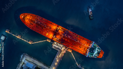 Aerial top view industrial crude oil fuel tanker ship at terminal industrial port,  Tanker ship unloading crude oil, Industry refinery fuel chemical import export business logistic and transportation. photo