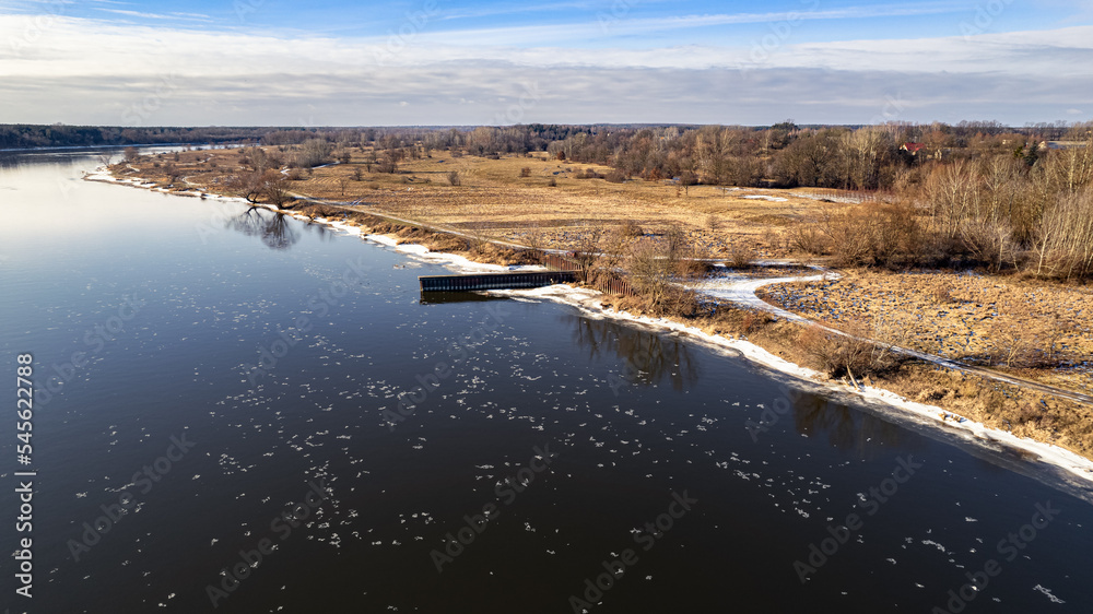 The bank of the Narew River in winter, near the dam in Dębe The bank of the Narew River in winter, near the dam in Dębe