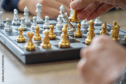 The company is businessman is hands move chess on the game plan to win the business in the market. concept of leadership