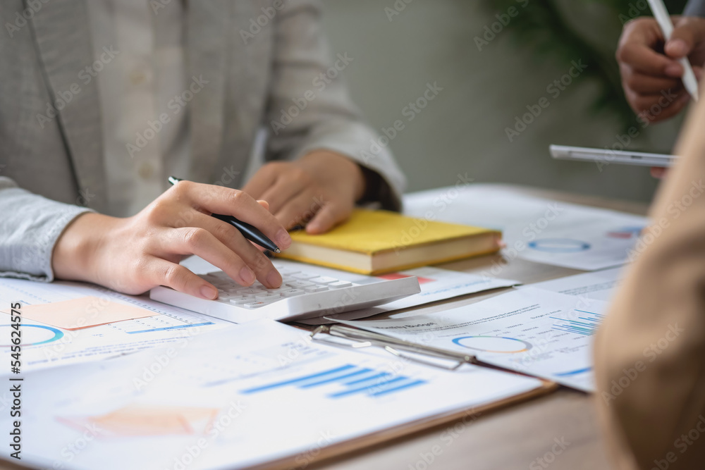 Marketing, Finance, Accounting, Planning, A team of businessmen plan with their laptops and graph charts for their profits and use a calculator to calculate their company is annual balance. Marketing, Finance, Accounting, Planning, A team of businessmen plan with their laptops and graph charts for their profits and use a calculator to calculate their company is annual balance.