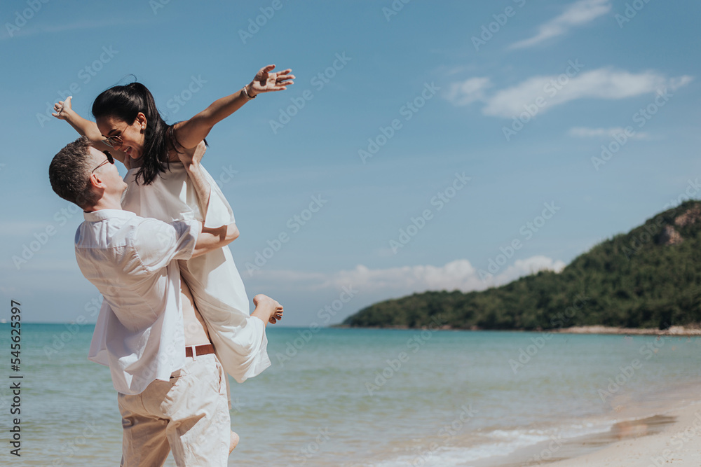 Romantic couple love happy and hugging on the beach. Young man and woman smiling and enjoying together on summer vacation. honeymoon lifestyle, Happy aniversary. Romantic couple love happy and hugging on the beach. Young man and woman smiling and enjoying together on summer vacation. honeymoon lifestyle, Happy aniversary.