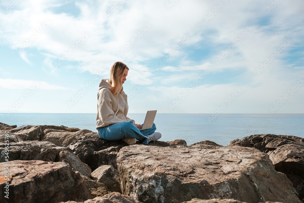 Remote work.Girl freelancer works remotely on the sea shore. workation, remote work,WFVH,Van Life vibes work from vacation home,work travel,remotely work.Travelling.Work from vacation remotely Remote work.Girl freelancer works remotely on the sea shore. workation, remote work,WFVH,Van Life vibes work from vacation home,work travel,remotely work.Travelling.Work from vacation remotely