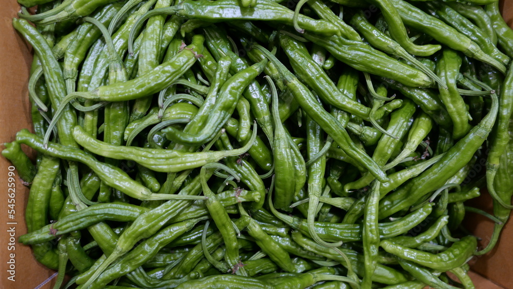 Full frame image of fresh green raw chilis in cardboard box Full frame image of fresh green raw chilis in cardboard box