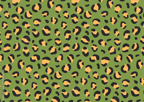 Seamless pattern. Leopard spots on a green background, fashionable leopard pattern.