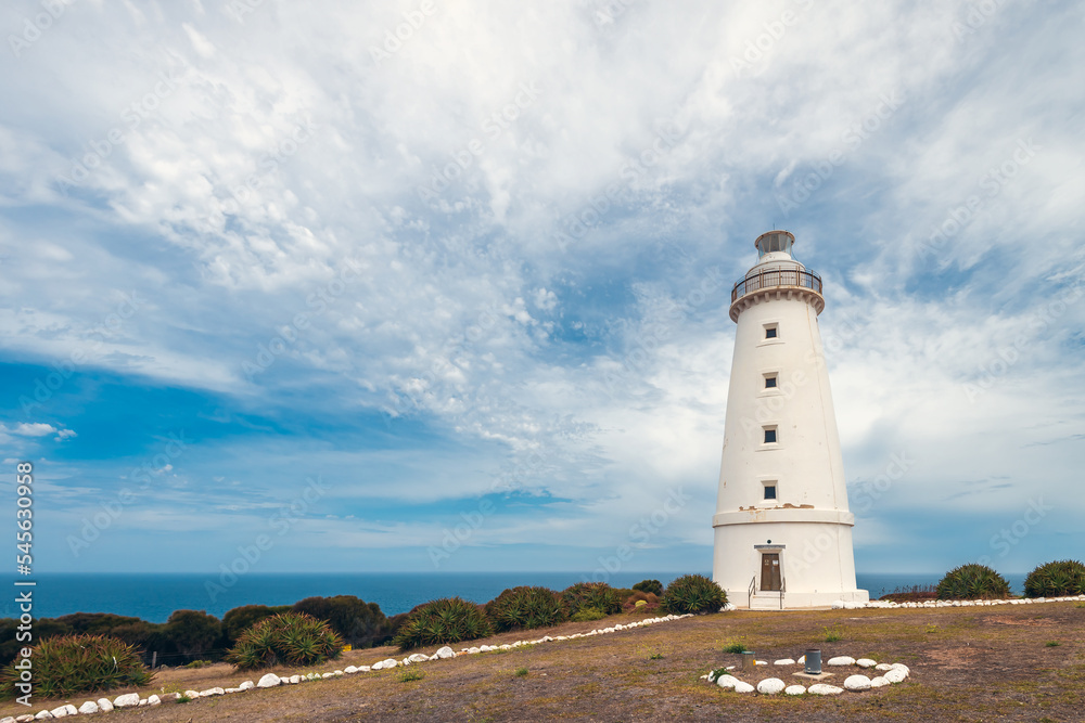 Cape Willoughby active lighthouse viewed against blue sky with clouds on a bright day, Kangaroo Island, South Australia