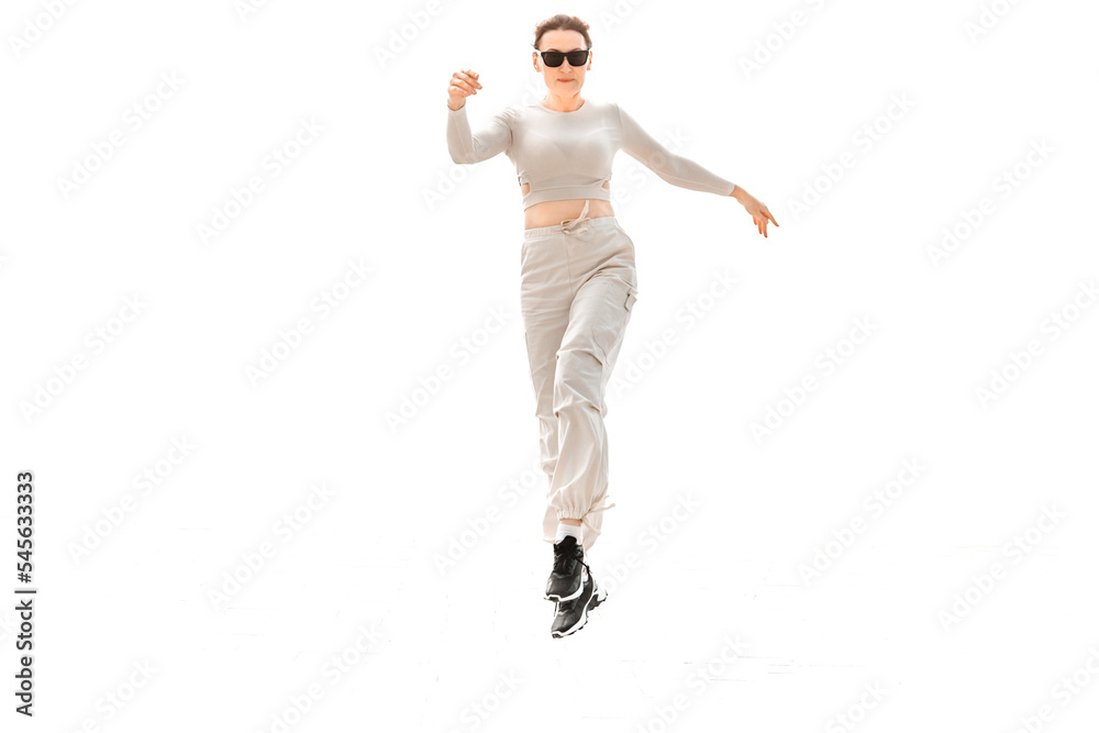 a full-length girl in light comfortable sportswear happily jumps and poses on a white background a full-length girl in light comfortable sportswear happily jumps and poses on a white background
