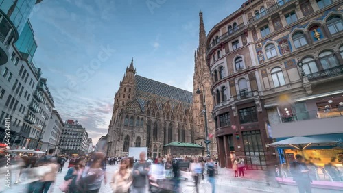 Vienna St. Stephen's Cathedral (Stephansdom) is the mother church of the Roman Catholic Archdiocese of Vienna timelapse, hyperlapse video. People walking on The Stephansplatz square, Austria city. photo