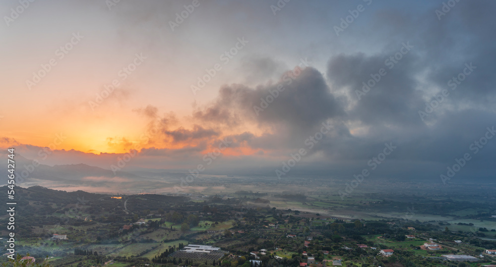 Panoramic view of Olbia at sunrise in the fog, Sardinia