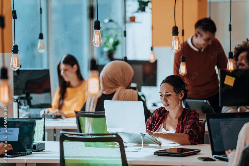 Multiethnic group of employees working in a marketing company. A group of colleagues is working on a project in modern offices Multiethnic group of employees working in a marketing company. A group of colleagues is working on a project in modern offices
