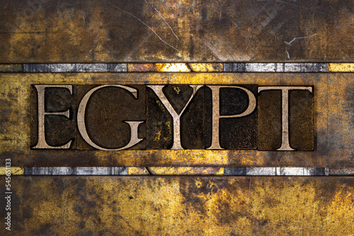 Egypt text with on grunge textured copper and gold background photo