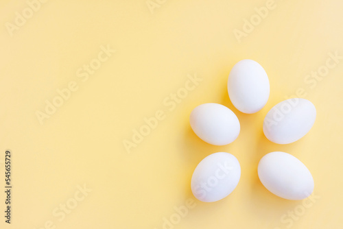 White eggs on yellow background, Duck eggs.