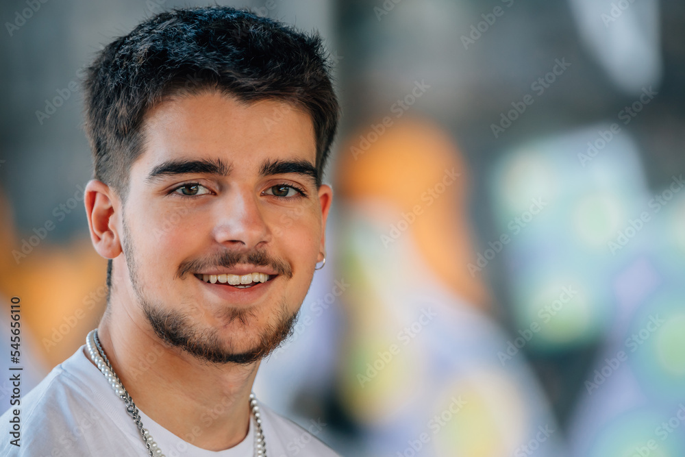 Fototapeta premium portrait of millennial young man with beard looking at camera
