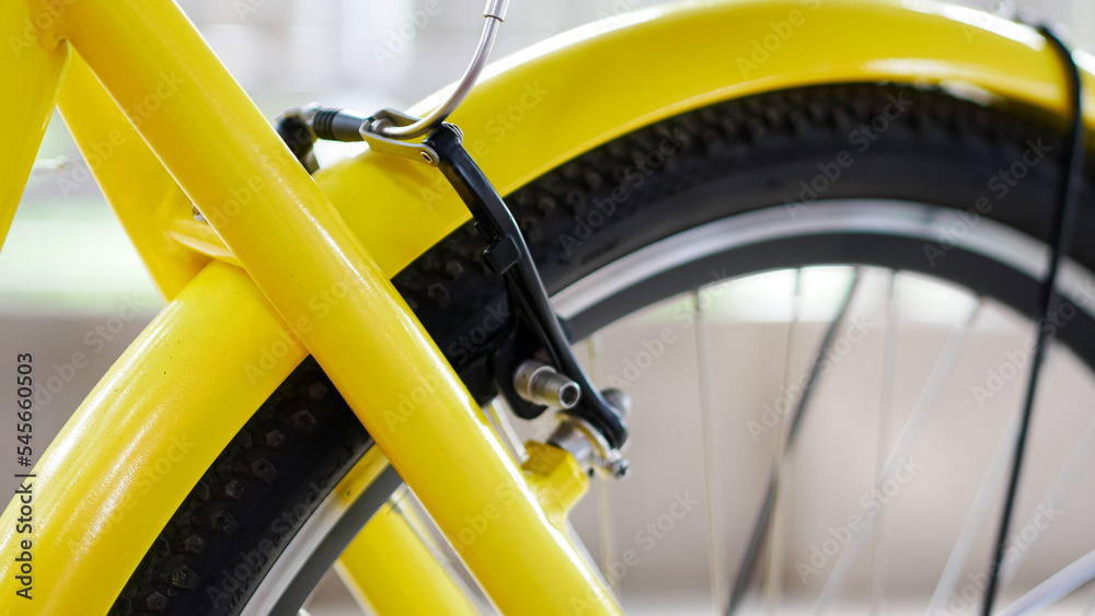close up of yellow bicycle wheel