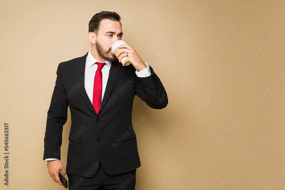 Busy salesman drinking coffee while going to work Busy salesman drinking coffee while going to work